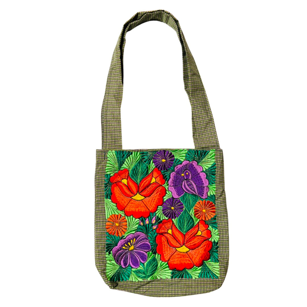 Woven green tote bag with red and purple flowers embroidered on the front.