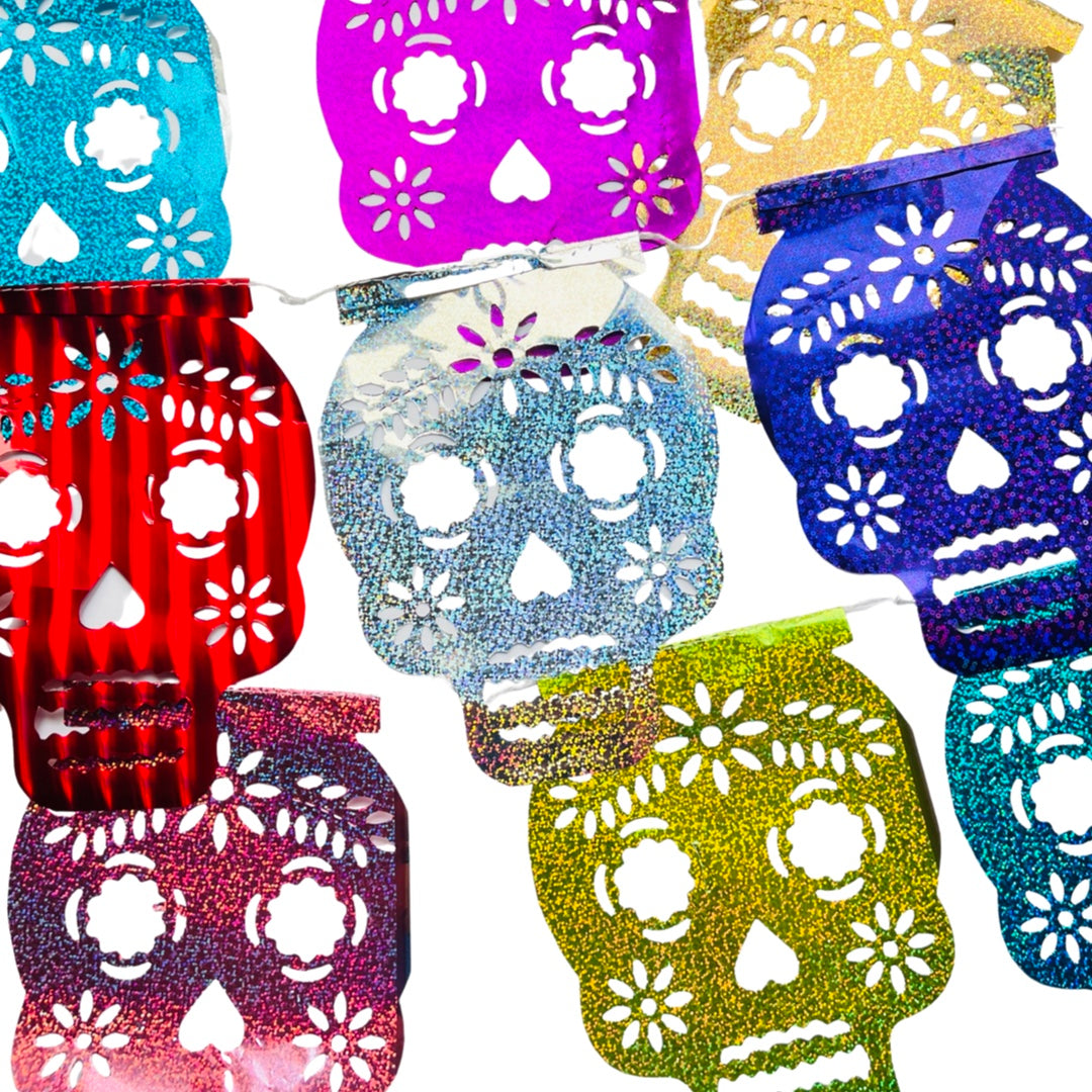 A papel picado foil glittery banner of various colors and sugar skulls   design. Papel picado , or perforated paper, is a traditional Mexican decorative craft made by cutting elaborate designs into sheets of tissue paper.