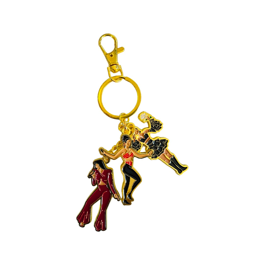 Gold colored keychain with 3 images of Selena in her iconic outfits. Purple Jumper, Red bustier and black ruffle skirt with bustier.