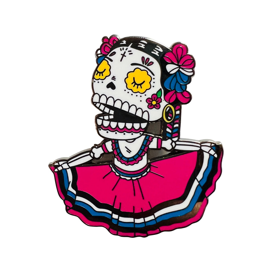 Folklorico Calavera Enamel pin featuring a pink dress with white, black and blue stripes