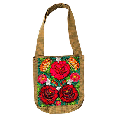 Woven tan tote bag with red, orange and white flowers embroidered on the front.