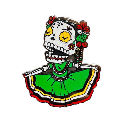 Folklorico Calavera Enamel pin featuring a green dress with red, white, black and yellow stripes