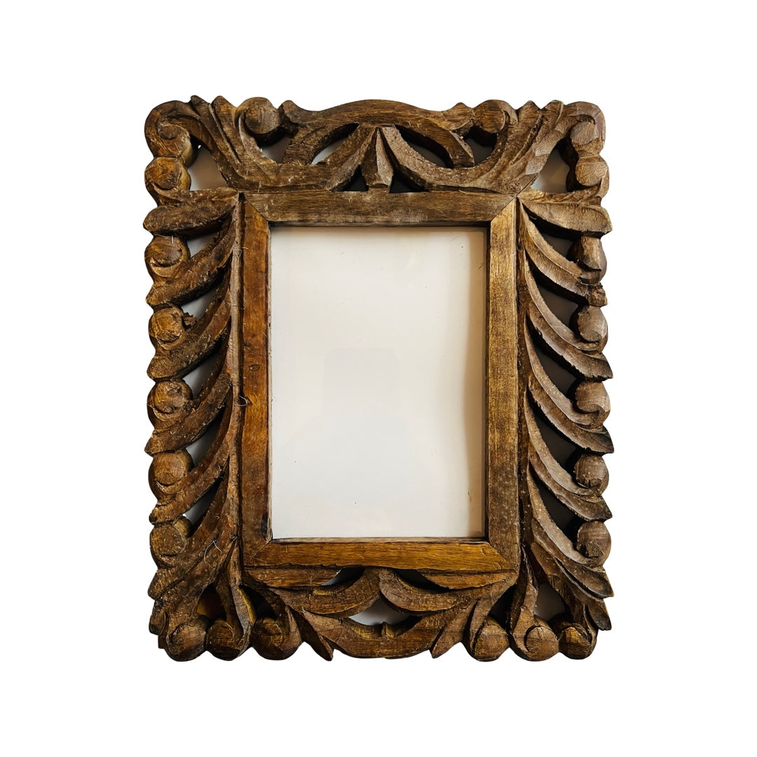 wooden photo frame that features a hand carved design