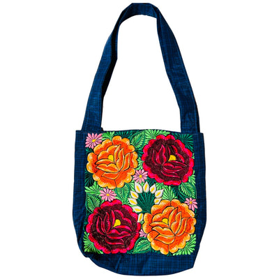 Woven navy blue tote bag with red and orange flowers embroidered on the front.