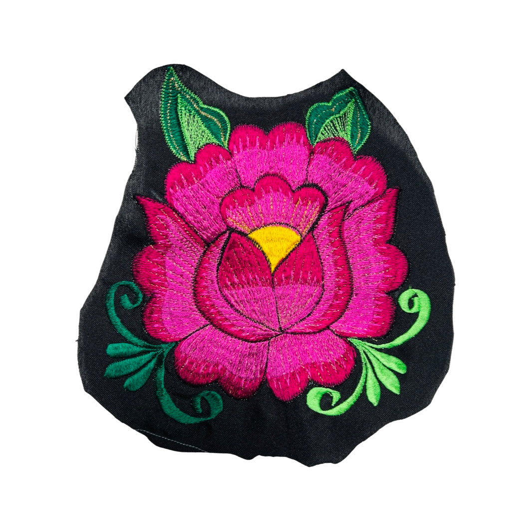 Woven pink flower embroidered on black fabric.