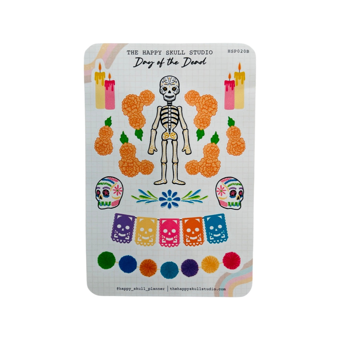 Sticker sheet that features marigold bundles, two sets of candles, two colorful sugar skulls, a skull papel picado banner, a pom pom garland and a smiling skeleton in the center.