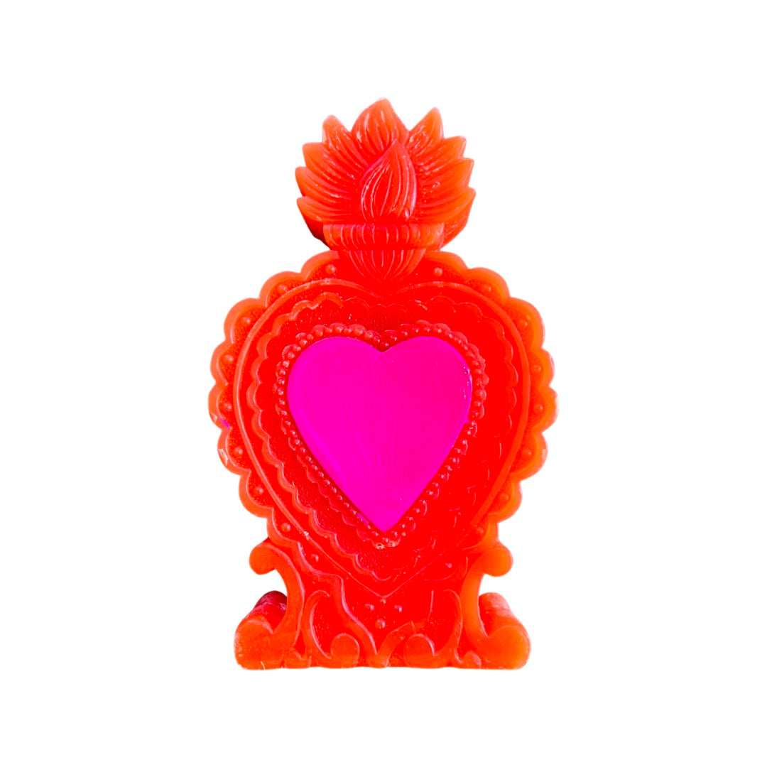 Red milagro heart candle with a pink heart in the center