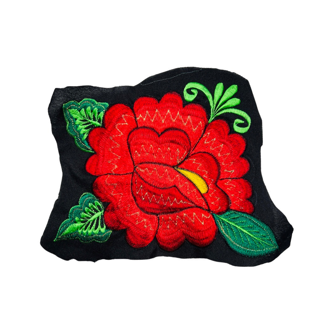 Woven red flower embroidered on black fabric.