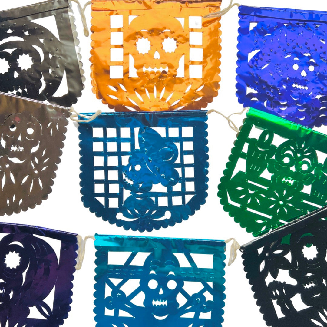 Dia de los Muertos papel picado metallic banner in various colors and various skull & skeleton designs. Papel picado , or perforated paper, is a traditional Mexican decorative craft made by cutting elaborate designs into sheets of tissue paper.