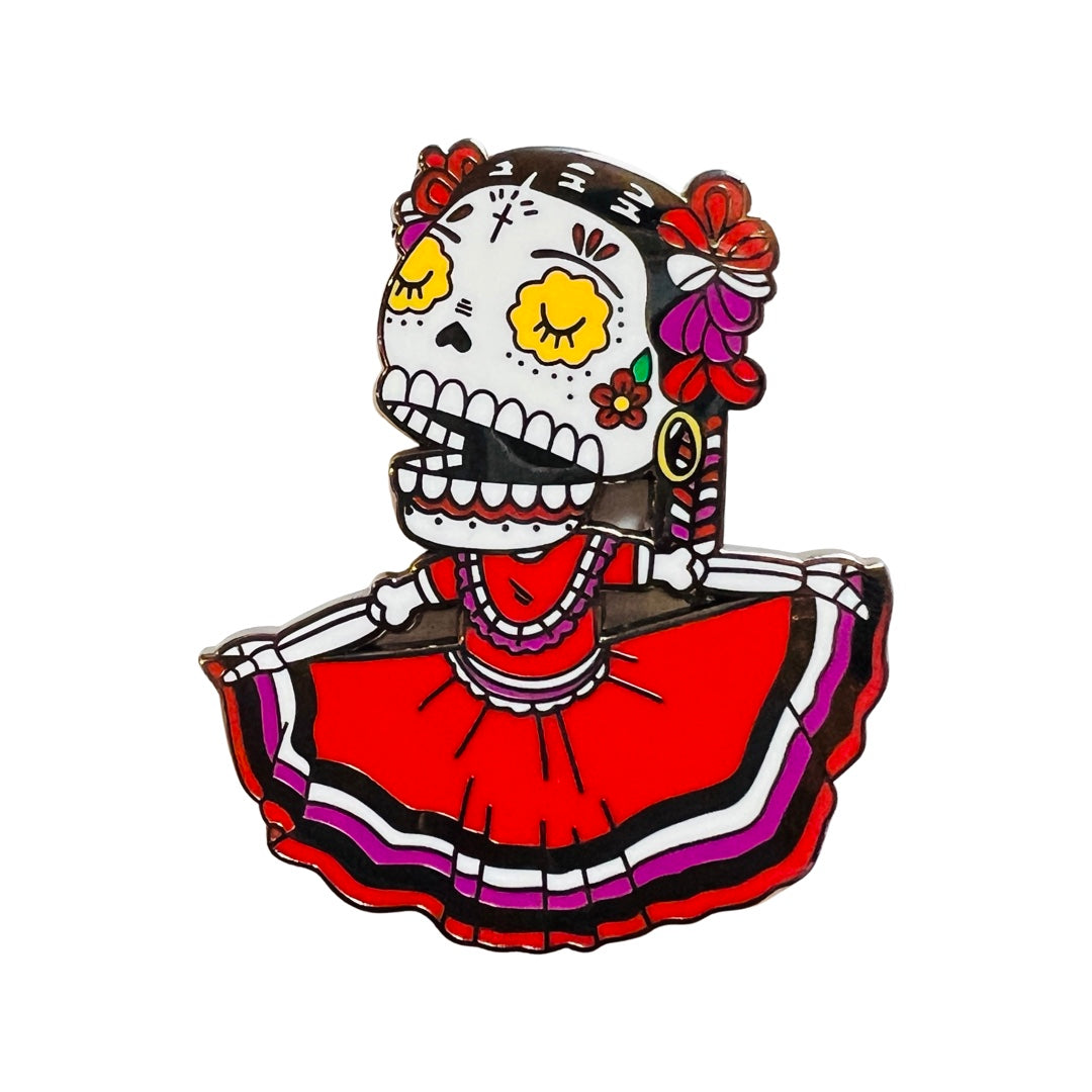 Folklorico Calavera Enamel pin featuring a red dress with white, black and pink stripes