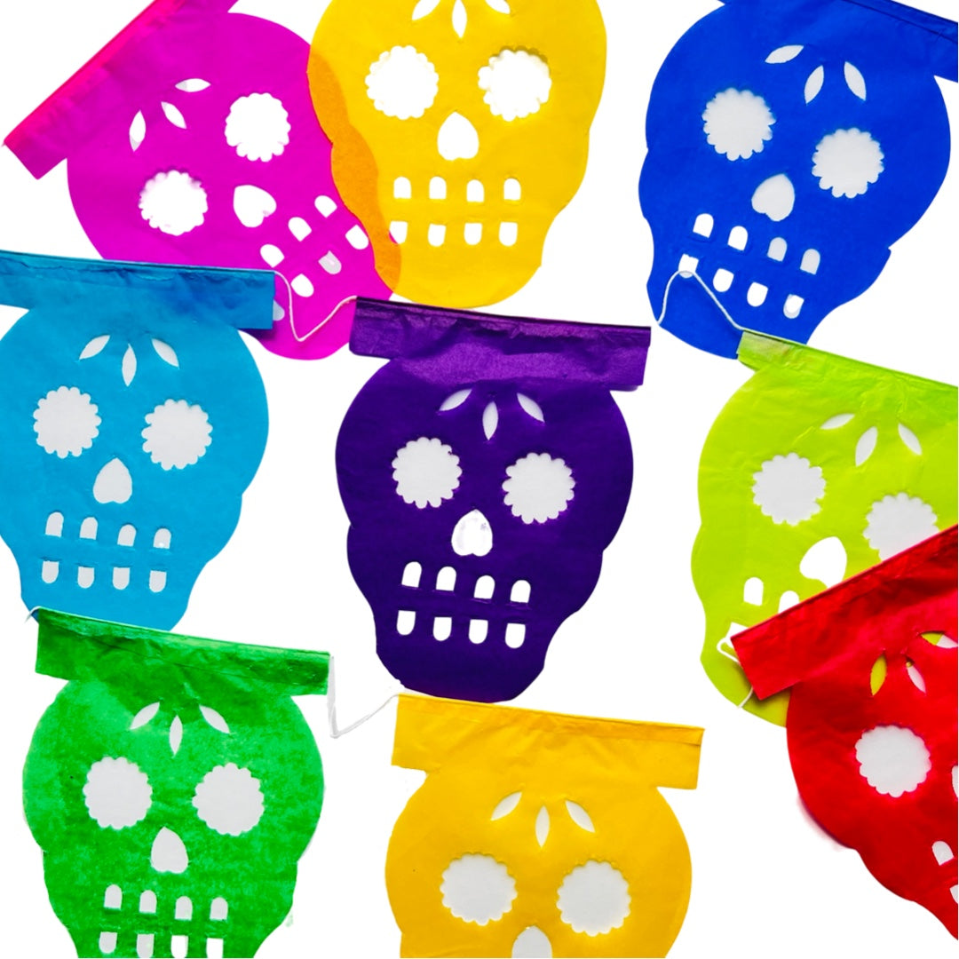 A papel picado banner of various colors and features a sugar skull  design. Papel picado , or perforated paper, is a traditional Mexican decorative craft made by cutting elaborate designs into sheets of tissue paper.