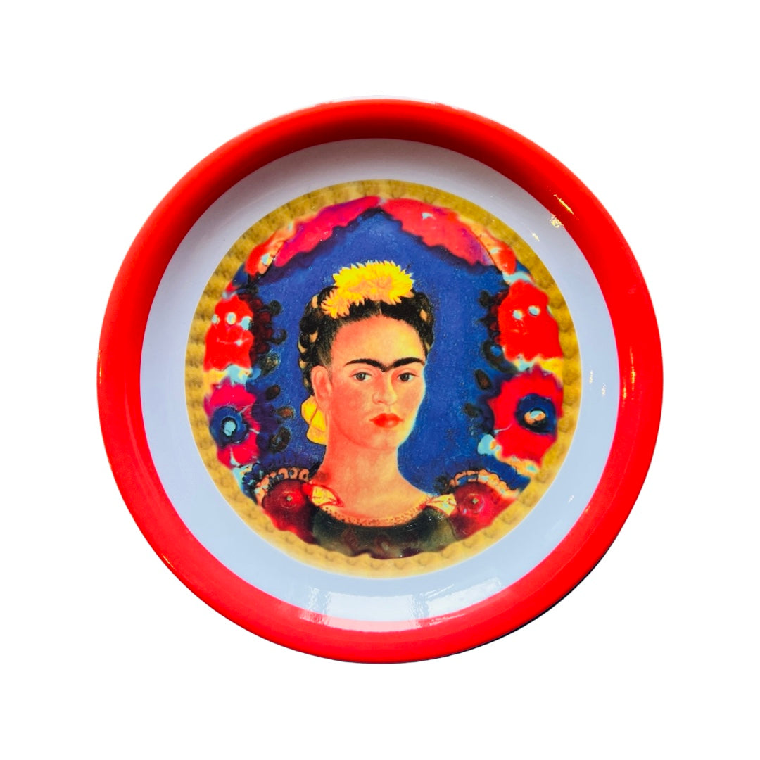 Single melamine plate that features an image of Frida Kahlo in the center and a red colored rim.