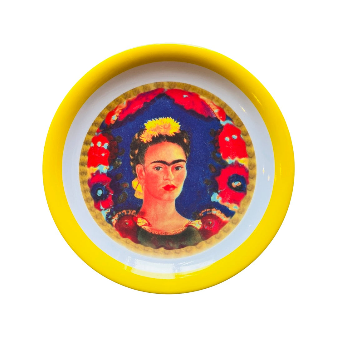 Single melamine plate that features an image of Frida Kahlo in the center and a yellow colored rim.